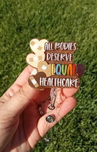 Load image into Gallery viewer, All Bodies Deserve Equal Healthcare Badge Reel